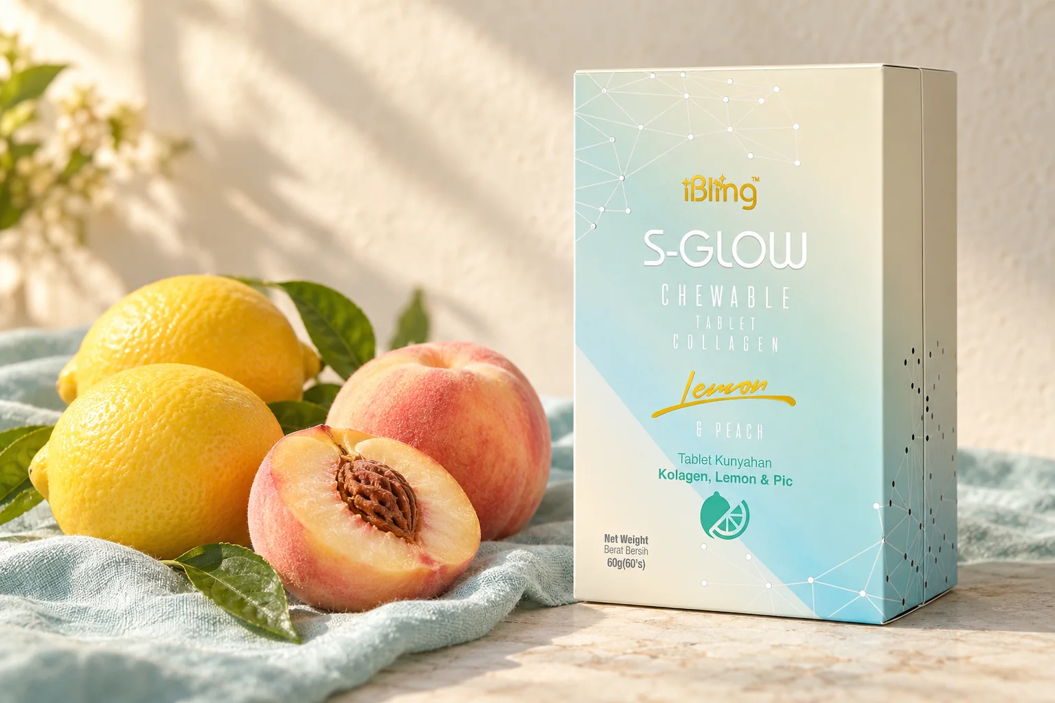The iBling S-GLOW box beside fresh lemons with leaves and a ripe peach on aqua linen
