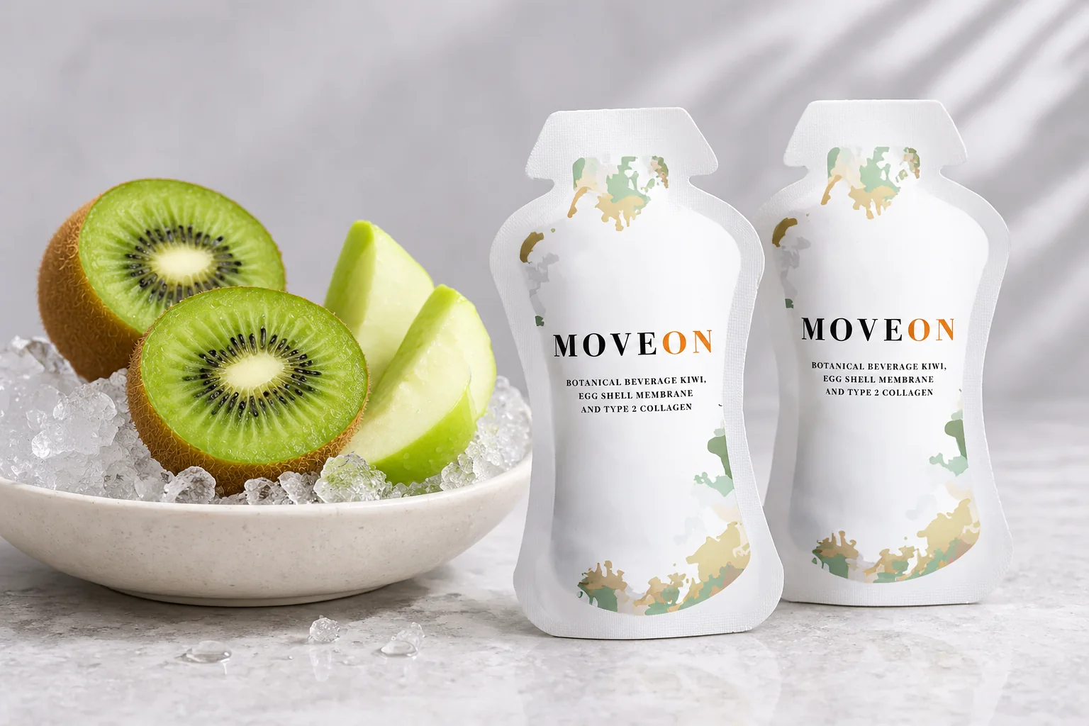 Two MOVEON sachets beside a dish of crushed ice with halved kiwi and green apple wedges
