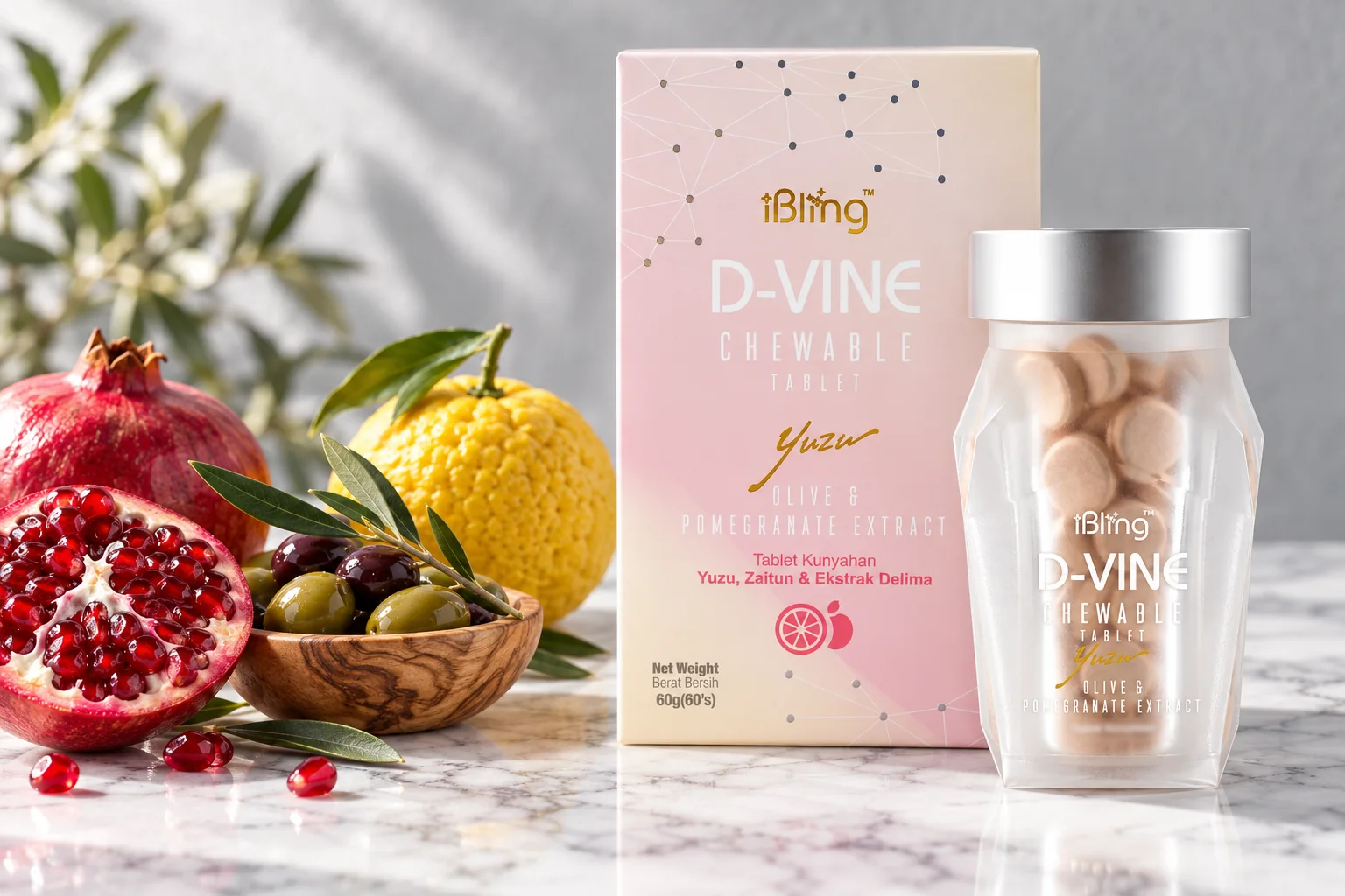 The D-VINE box and jar beside a halved pomegranate, olives and a yuzu on white marble