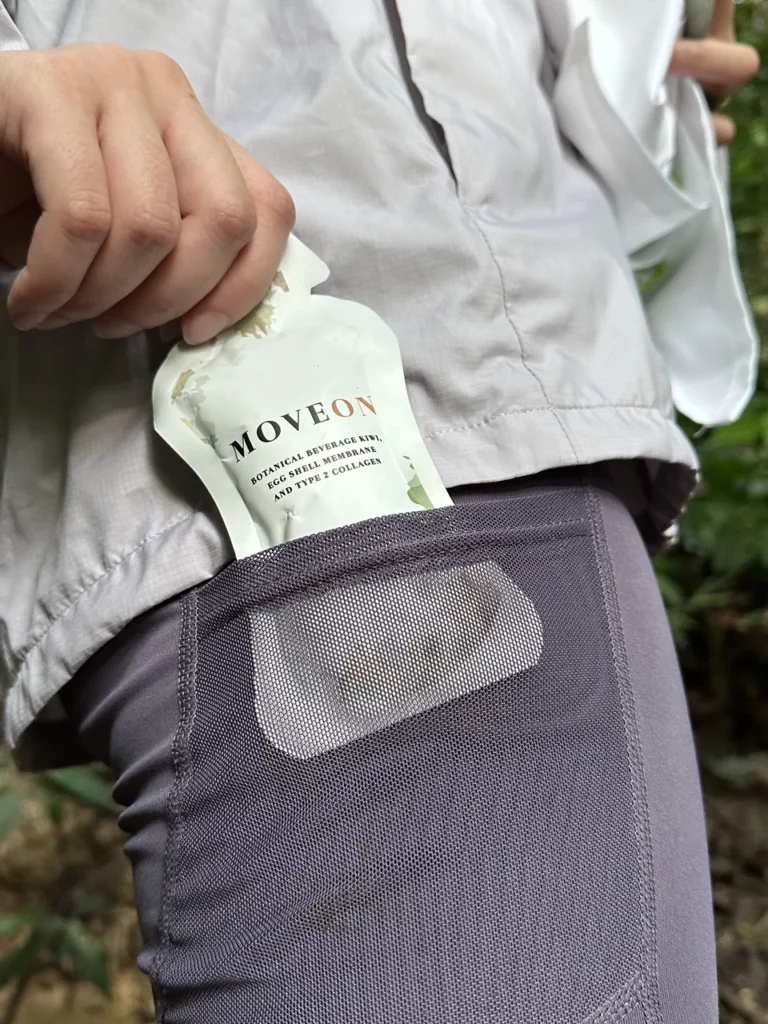 Walker sliding a MOVEON sachet into a leggings pocket