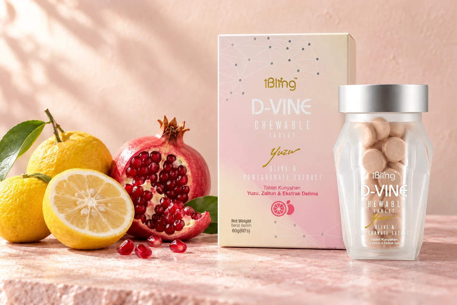 The D-VINE chewable collagen box and glass jar with fresh yuzu and an open pomegranate on blush stone