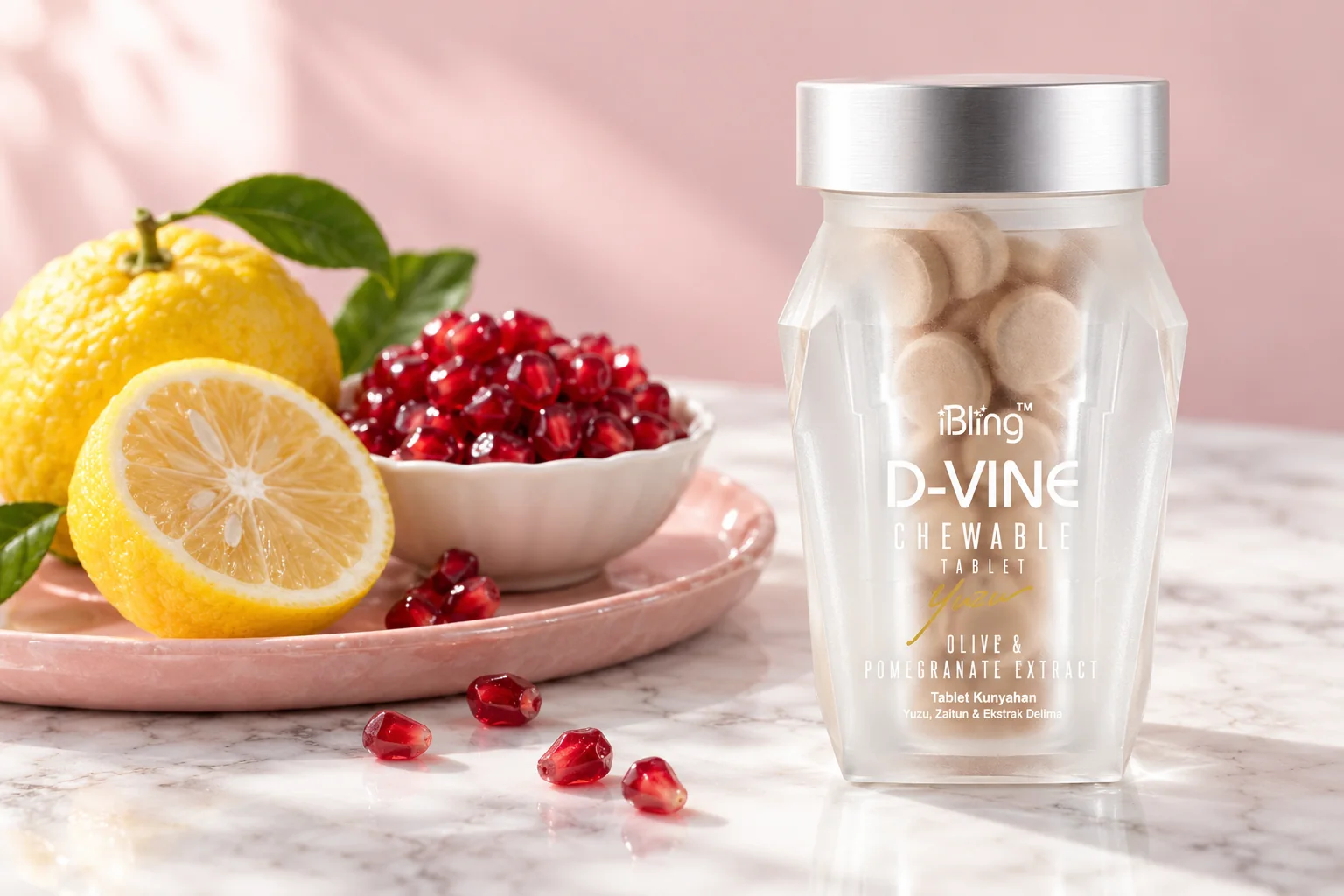 The D-VINE glass jar of chewable tablets with fresh yuzu and pomegranate seeds on white marble