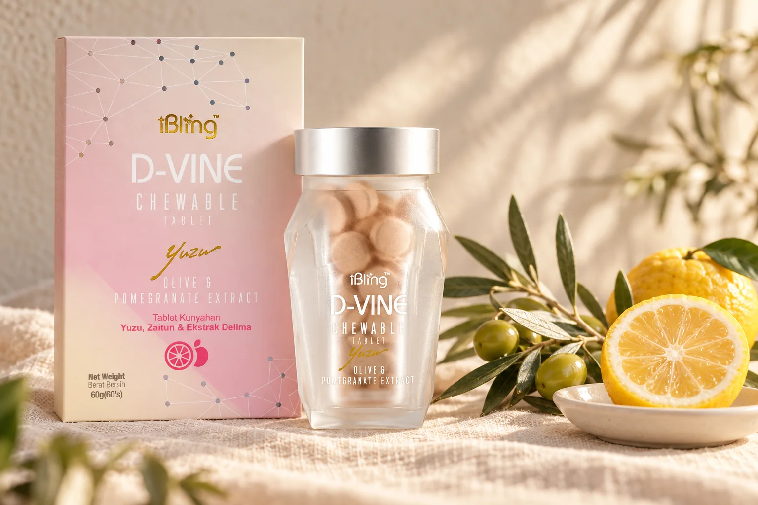 The D-VINE box and glass jar of chewable tablets with an olive sprig and a halved yuzu on cream linen
