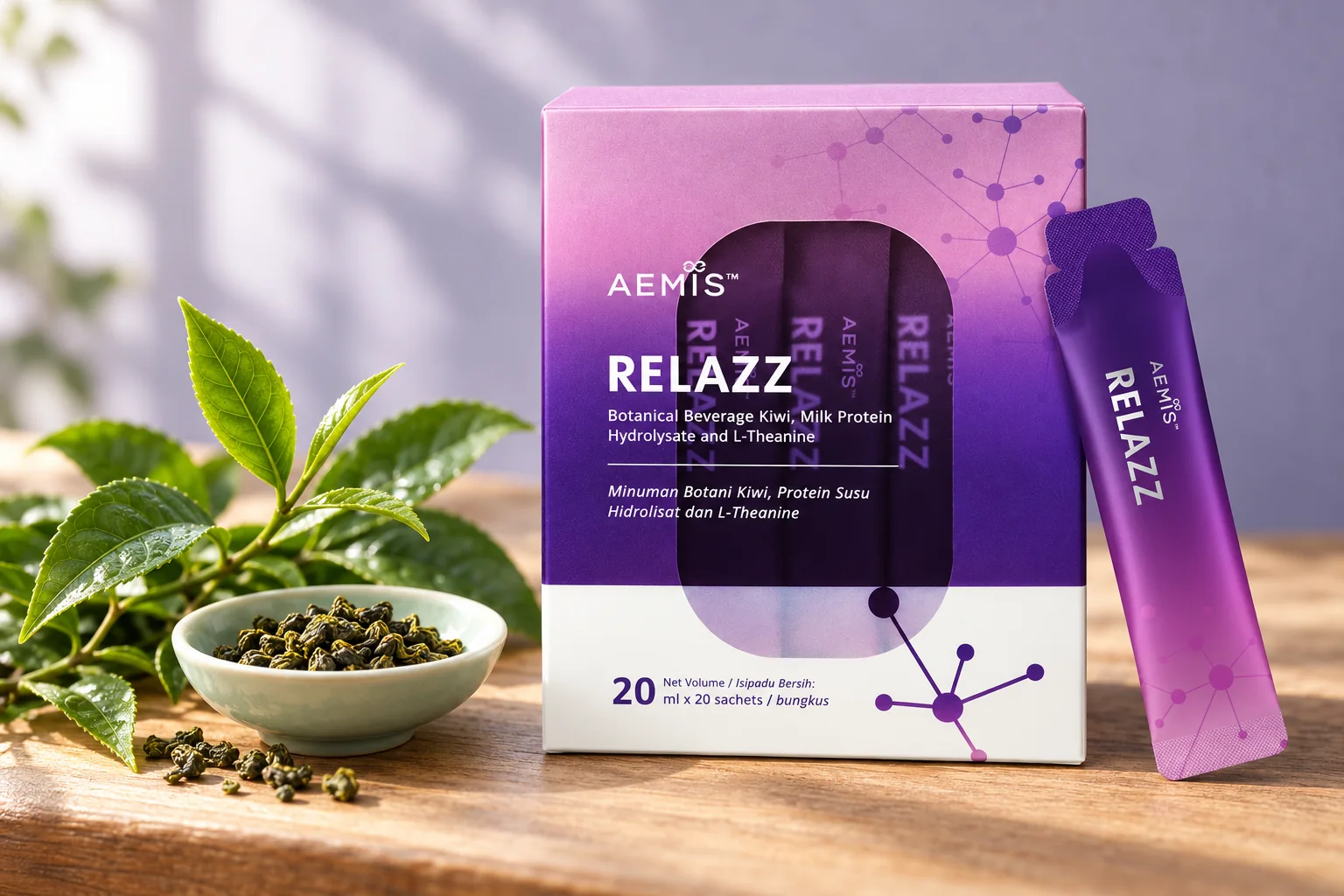 The RELAZZ box and sachet beside a fresh tea sprig and a dish of loose green tea leaves