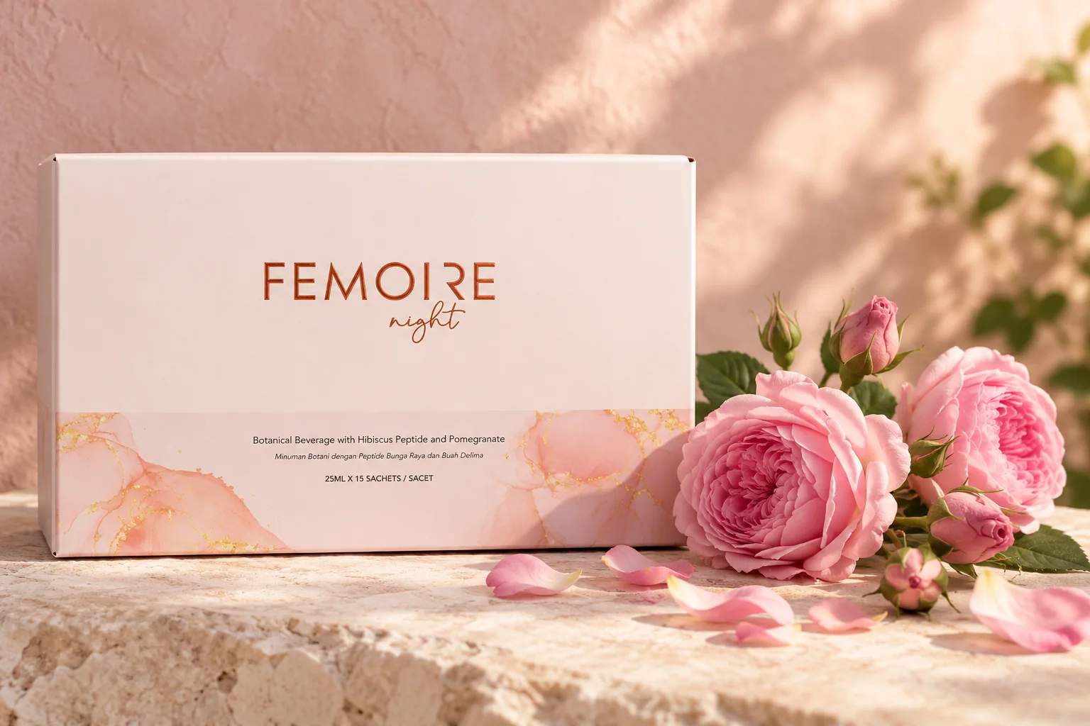 The Femoire Night box on pale limestone beside fresh pink damask roses and rose buds