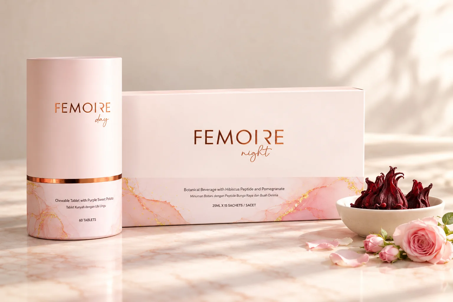 The Femoire Night box and the Femoire Day canister on pink marble with dried hibiscus flowers and pink rose buds