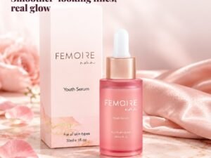 FEMOIRE Youth Serum with rose petals and silk on a marble vanity