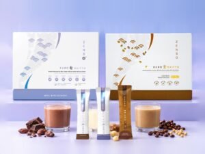 ZENSO Kuro Daitto meal replacement: the box for Chocolate and Vanilla Macadamia, the Coffee box, a stick sachet and a shake of each flavour