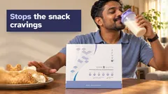 A man drinking a vanilla Kuro Daitto shake and pushing away a plate of curry puffs and crackers, the Kuro Daitto box on the table. Stops the snack cravings.