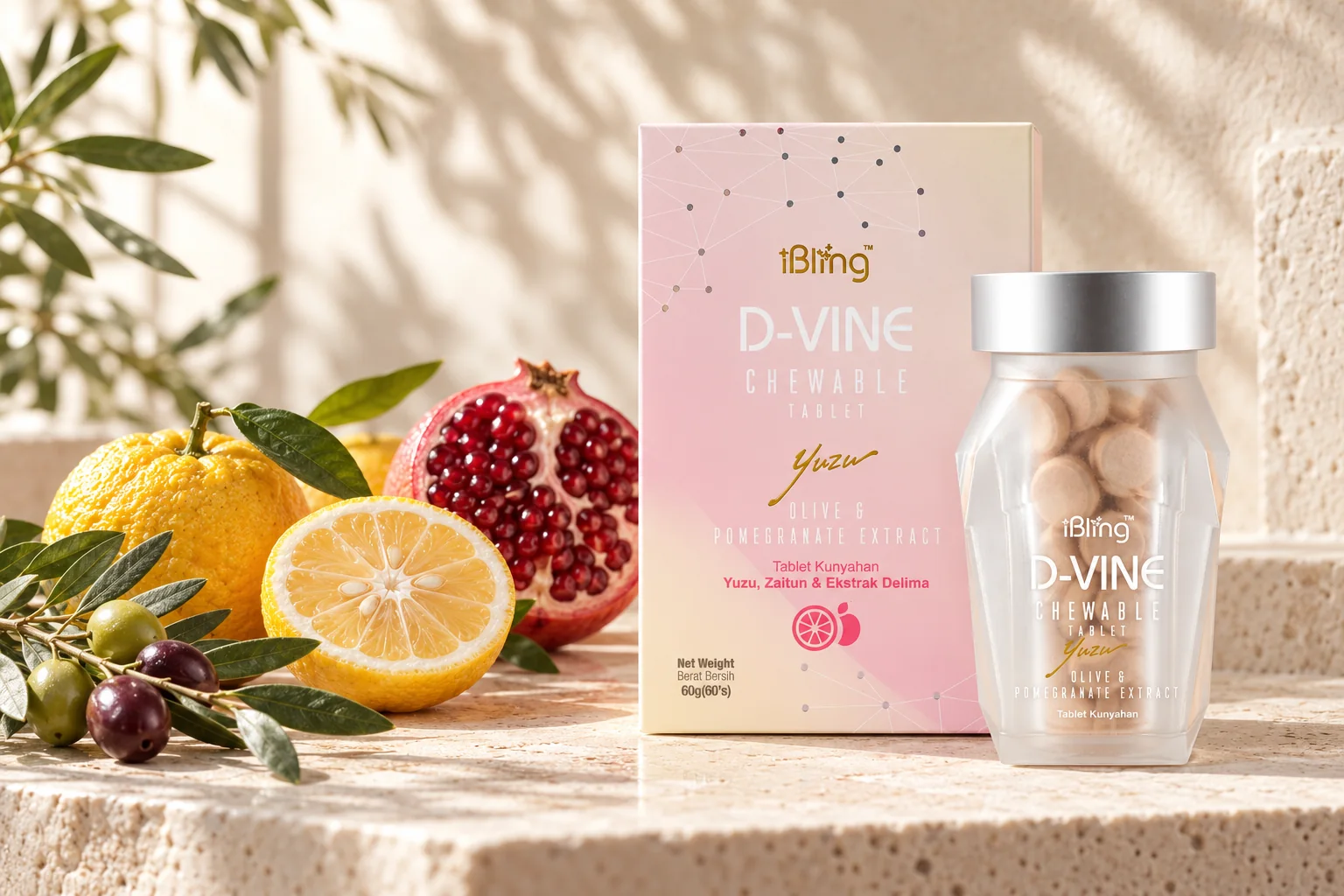 The D-VINE box and bottle beside yuzu fruit, an olive branch and a halved pomegranate