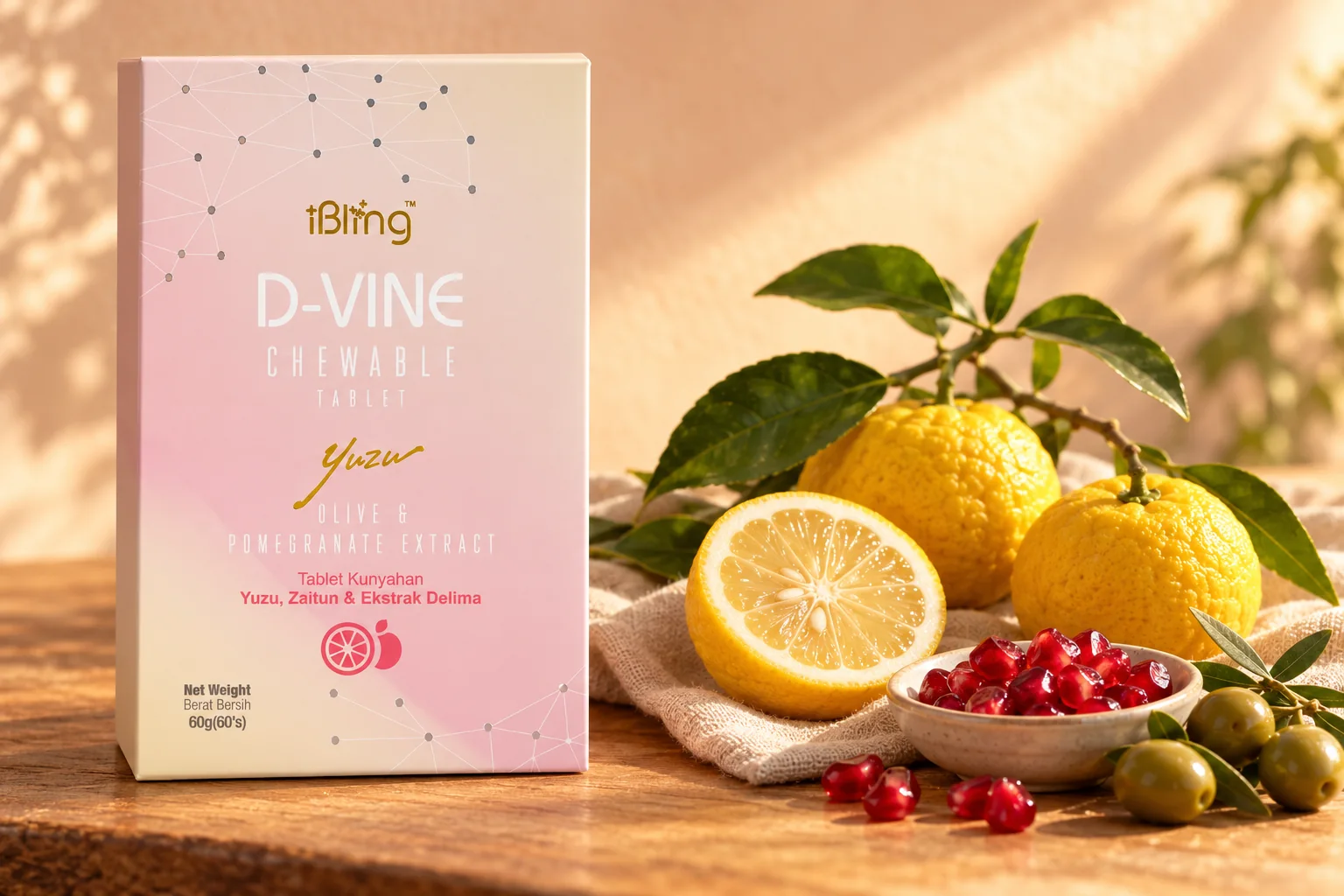 The D-VINE box beside a leafy yuzu branch, a halved yuzu, pomegranate seeds and olives on a wooden bench