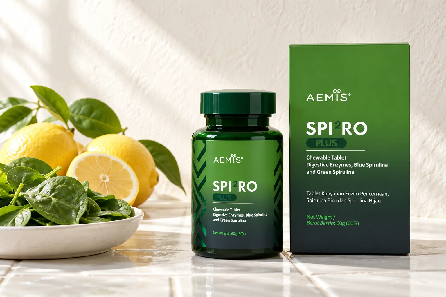 The SPIRO Plus box and bottle beside fresh spinach leaves and lemons on white ceramic tiles