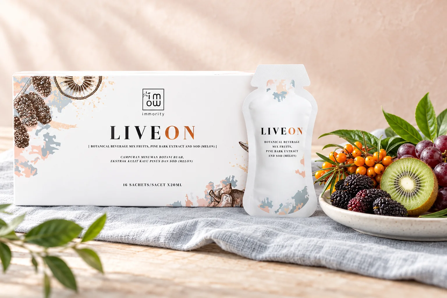 The wide LIVEON box and a sachet beside sea buckthorn berries, mulberries, kiwi and grapes on grey-blue linen