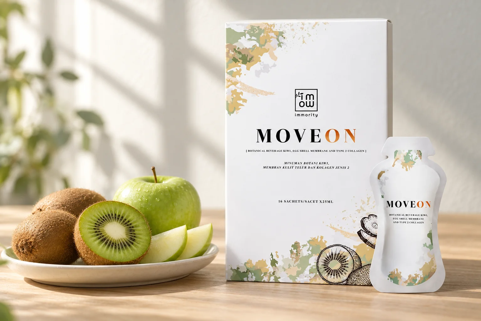 The MOVEON box and one sachet beside a halved kiwi, whole kiwis and a green apple on a pale oak table