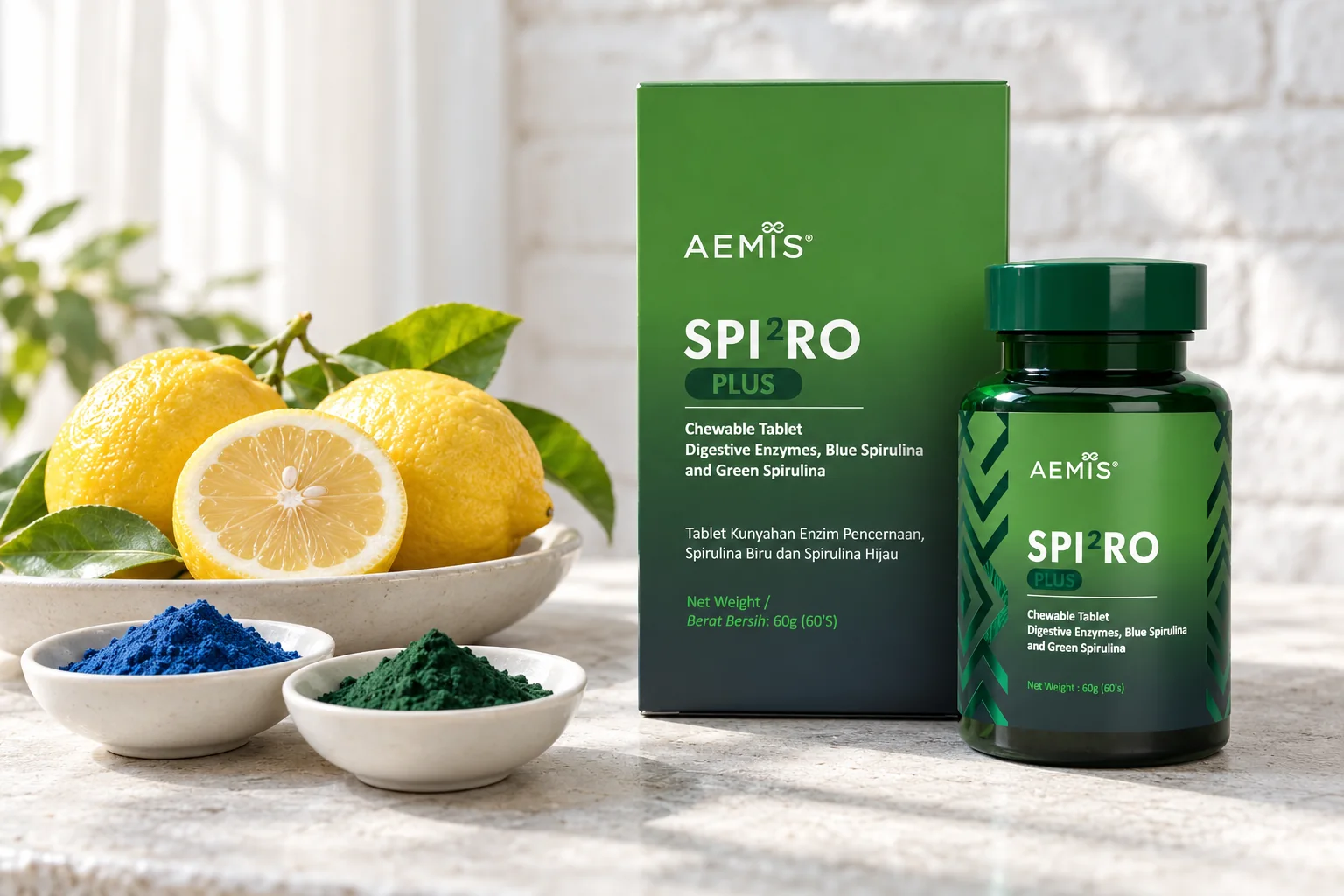 The SPIRO Plus box and bottle beside lemons and small dishes of blue and green spirulina